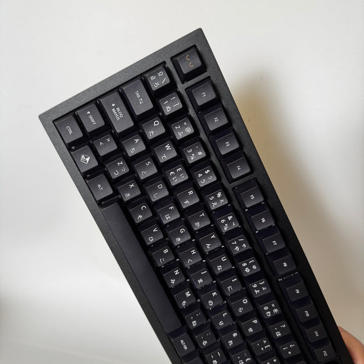 Black mechanical keyboard on a light gray background